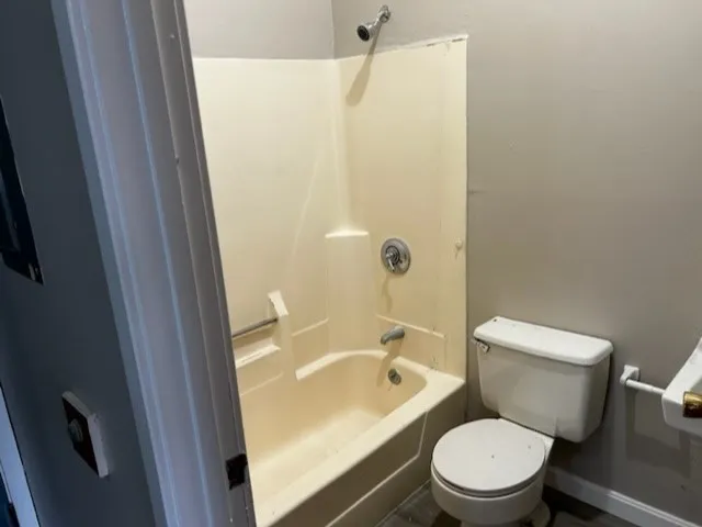 a white toilet sitting next to a bathroom sink