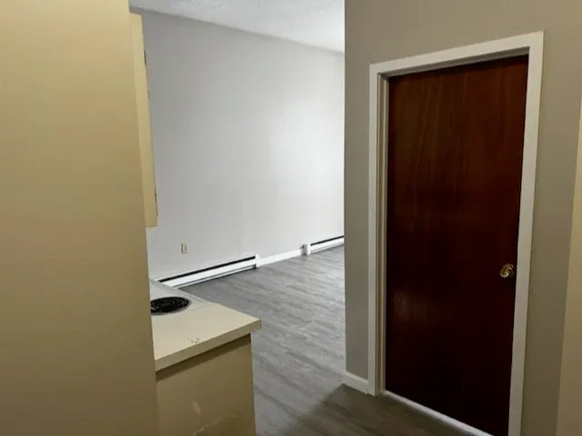 a view of an entryway with wooden floor