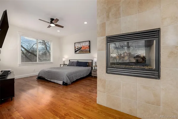 a bedroom with a bed and a painting on the wall
