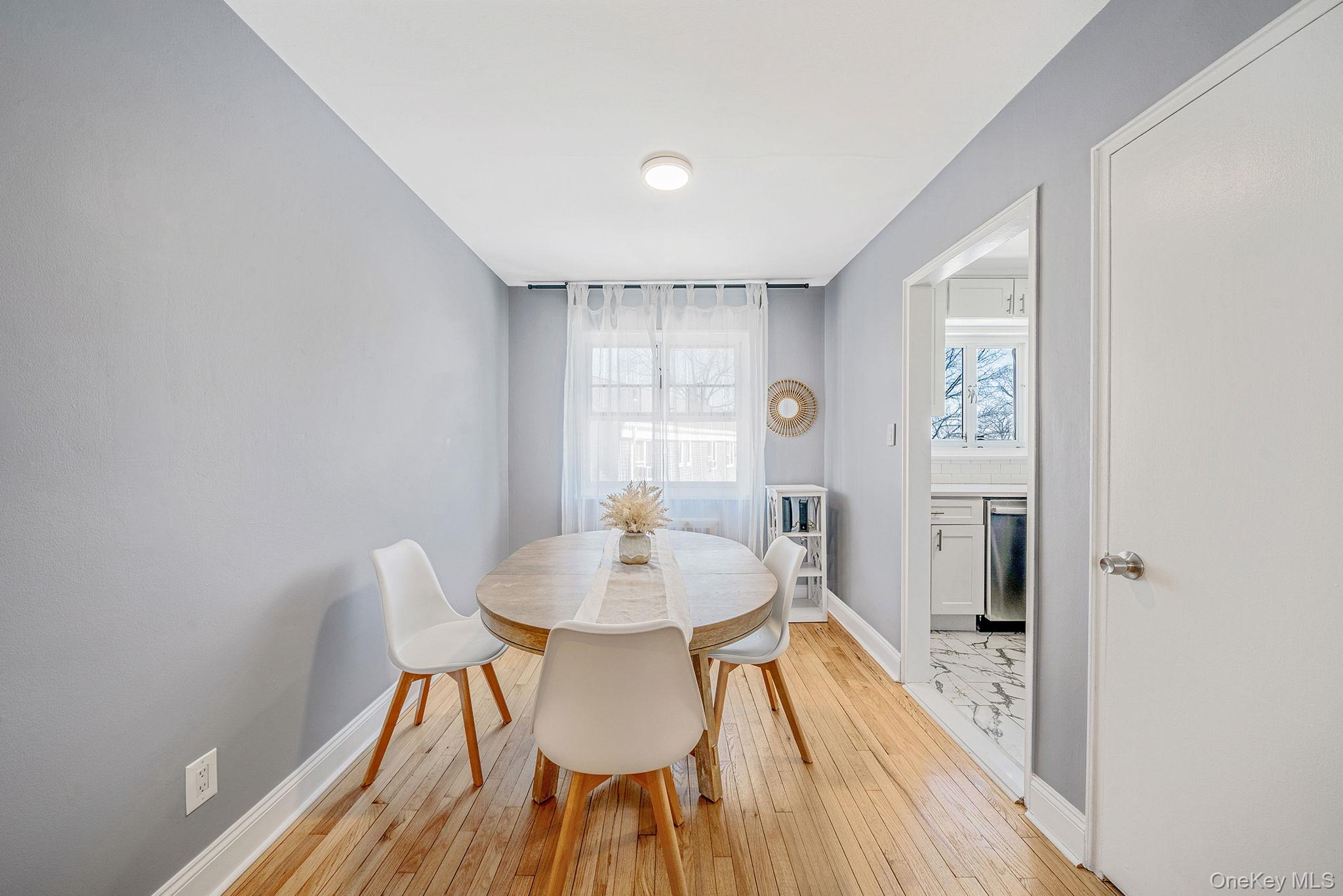 224-24 Manor Road, Unit UPPR Queens, NY 11427 - Photo 11 of 25 a view of a dining room with furniture and wooden floor