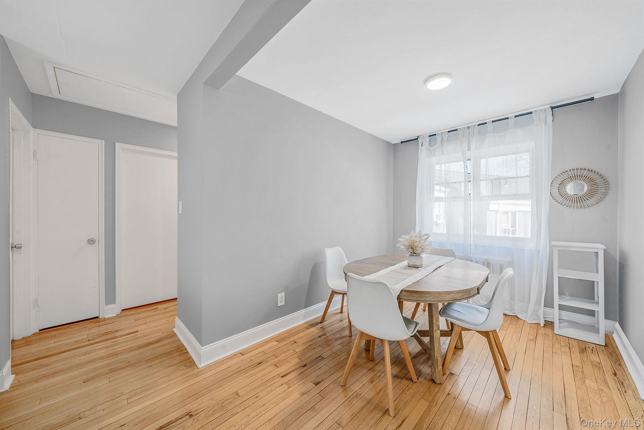 224-24 Manor Road, Unit UPPR Queens, NY 11427 - Photo 13 of 25 a view of a dining room with furniture and wooden floor