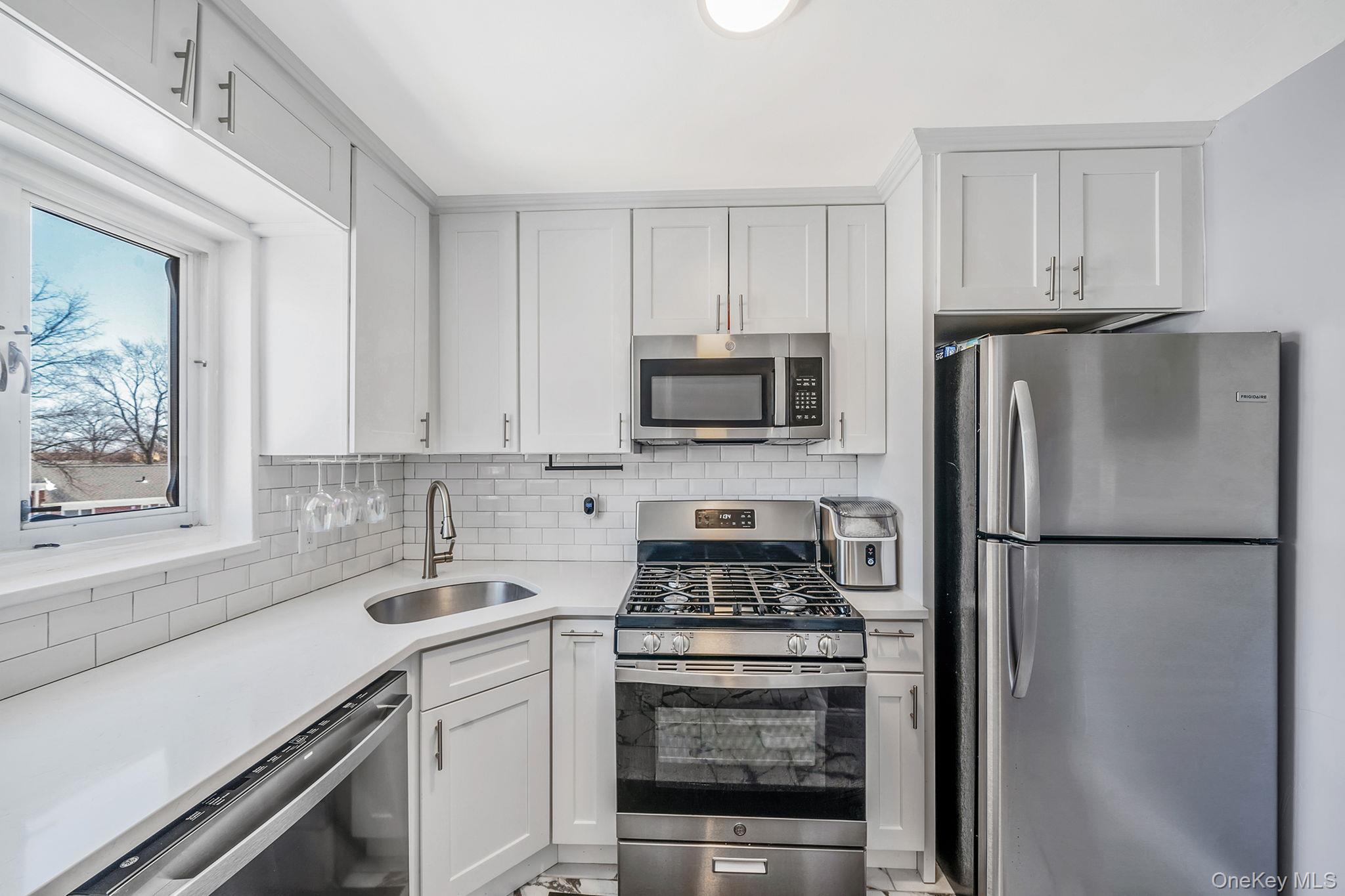 224-24 Manor Road, Unit UPPR Queens, NY 11427 - Photo 15 of 25 a kitchen with a refrigerator stove and sink