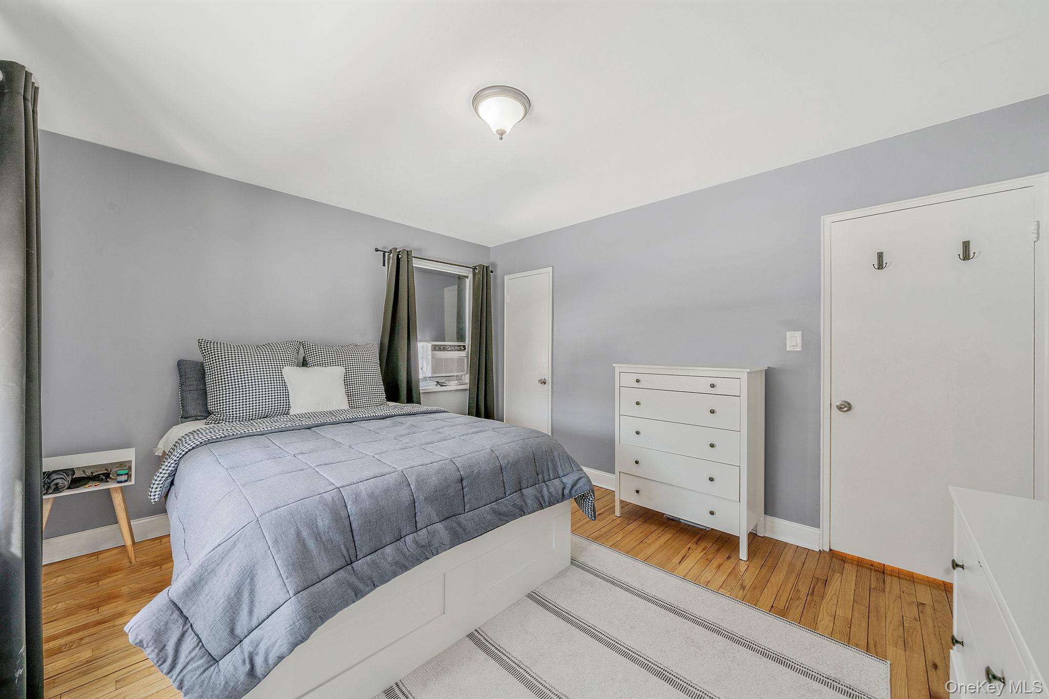 224-24 Manor Road, Unit UPPR Queens, NY 11427 - Photo 18 of 25 a bedroom with a bed and a dresser