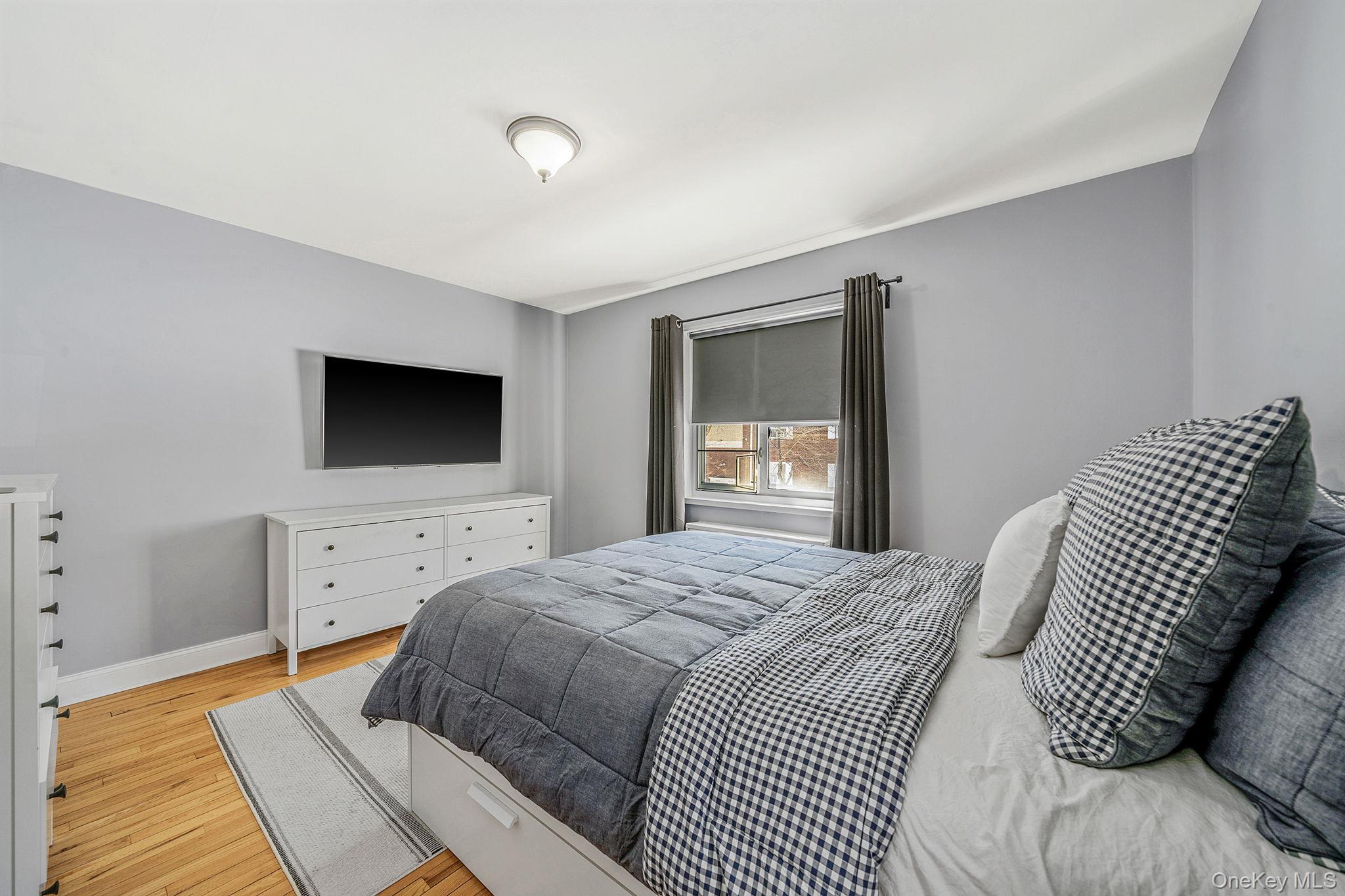 224-24 Manor Road, Unit UPPR Queens, NY 11427 - Photo 19 of 25 a bedroom with a bed and a flat screen tv