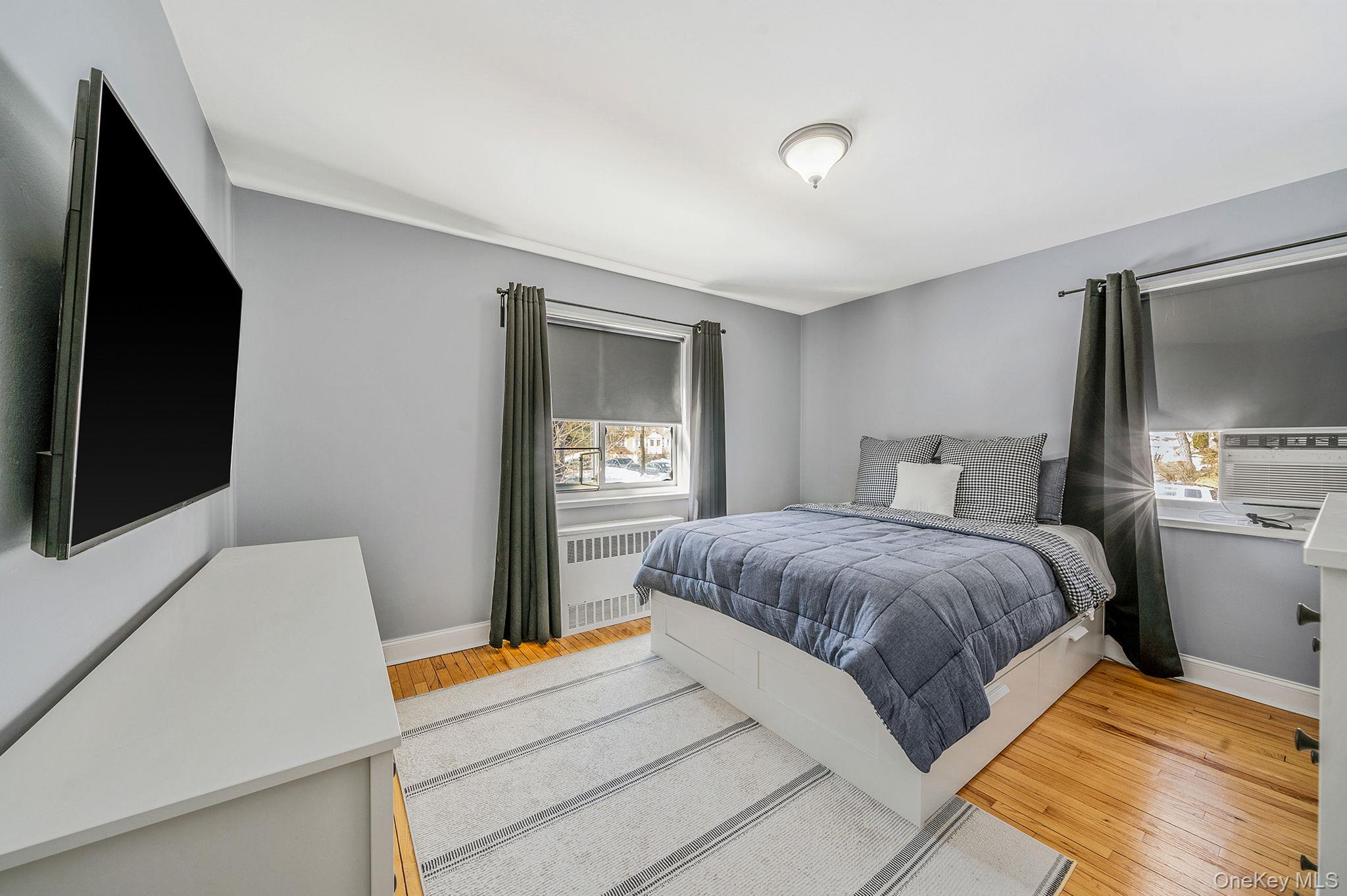 224-24 Manor Road, Unit UPPR Queens, NY 11427 - Photo 20 of 25 a bedroom with a bed and a flat screen tv