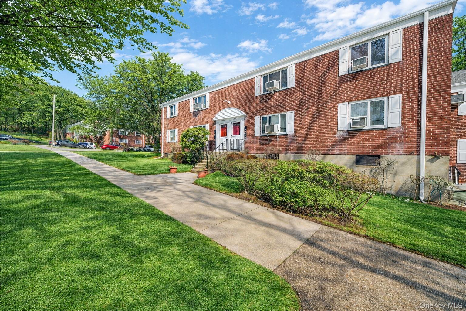224-24 Manor Road, Unit UPPR Queens, NY 11427 - Photo 2 of 25 a front view of a house with a yard