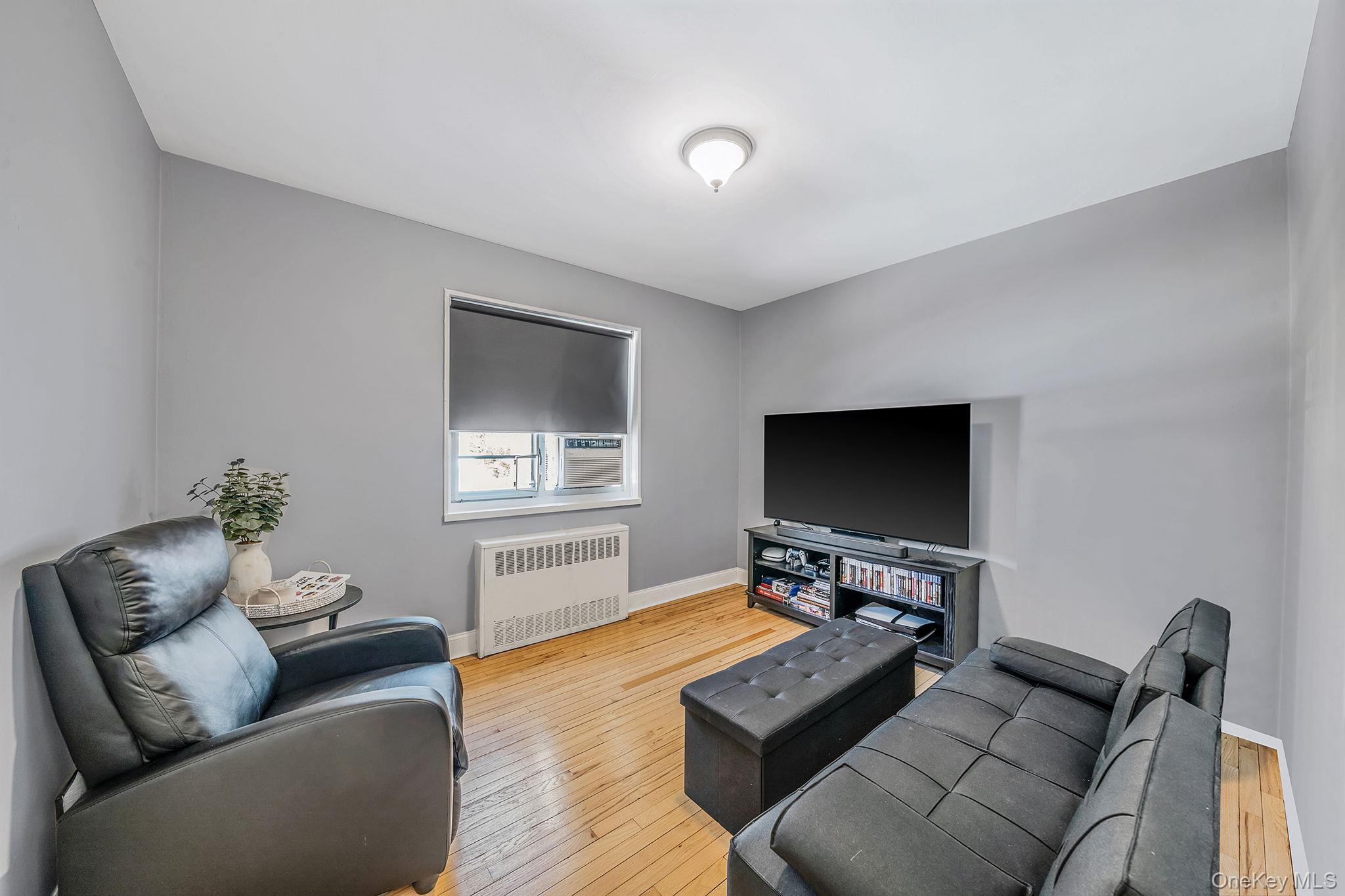 224-24 Manor Road, Unit UPPR Queens, NY 11427 - Photo 21 of 25 a living room with furniture and a flat screen tv