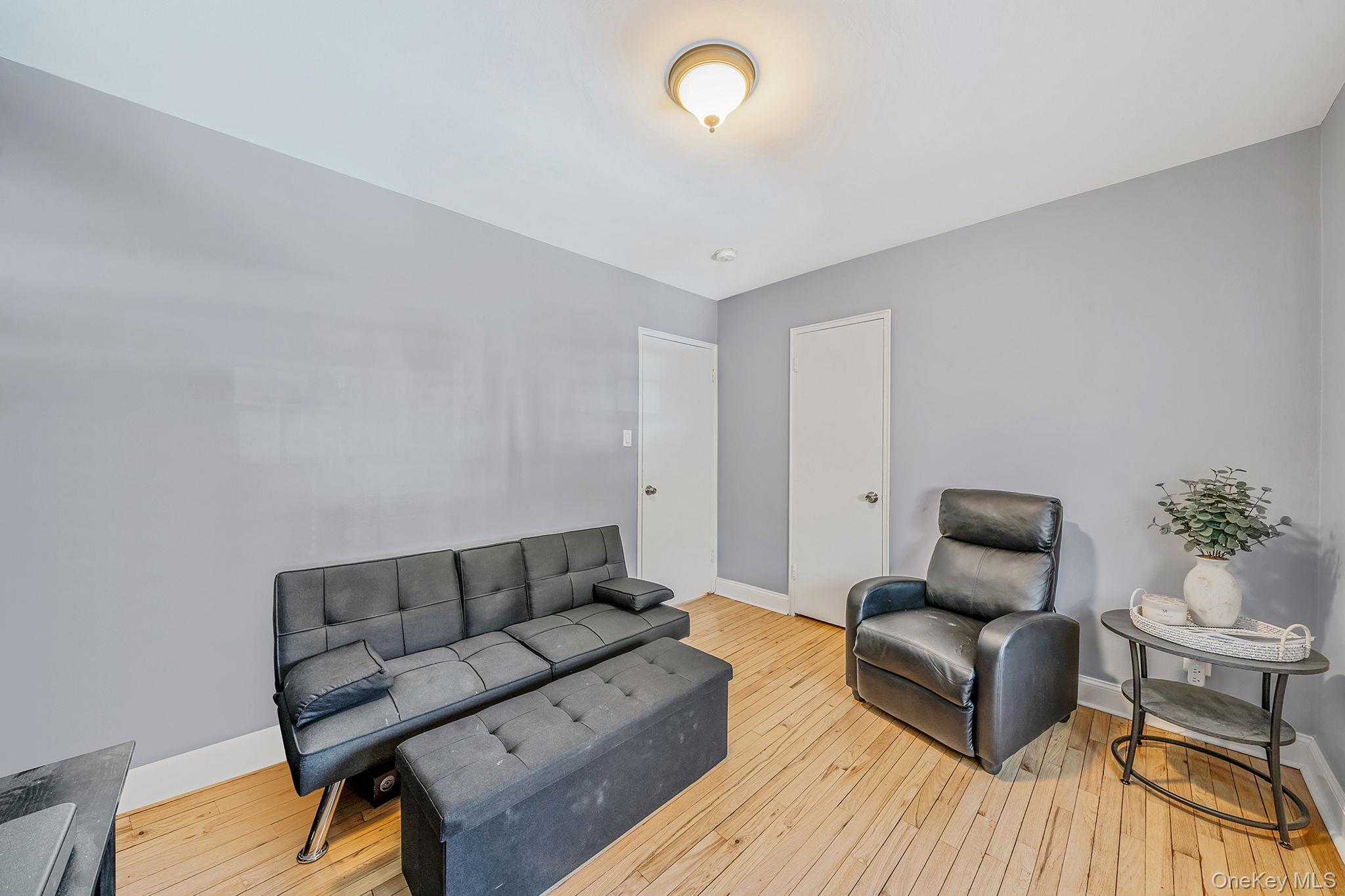 224-24 Manor Road, Unit UPPR Queens, NY 11427 - Photo 22 of 25 a living room with furniture and wooden floor