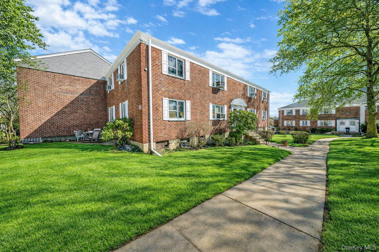224-24 Manor Road, Unit UPPR Queens, NY 11427 - Photo 3 of 25 a front view of house with yard and green space