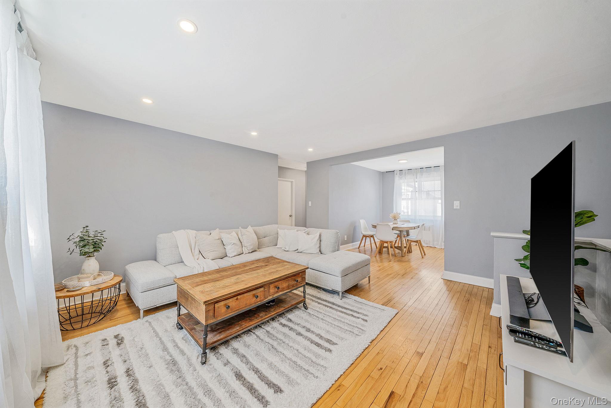 224-24 Manor Road, Unit UPPR Queens, NY 11427 - Photo 8 of 25 a living room with furniture and a flat screen tv