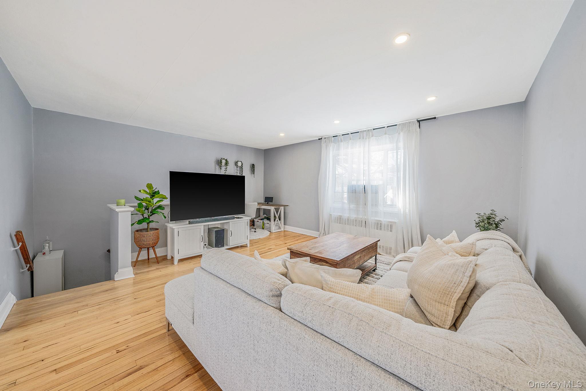 224-24 Manor Road, Unit UPPR Queens, NY 11427 - Photo 9 of 25 a living room with a bed and a flat screen tv