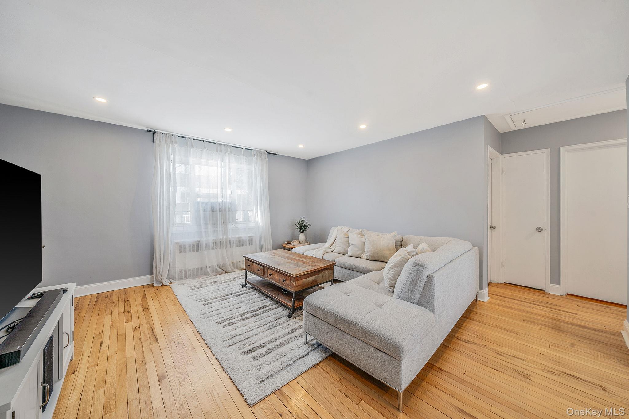 224-24 Manor Road, Unit UPPR Queens, NY 11427 - Photo 10 of 25 a living room with a couch and a flat screen tv