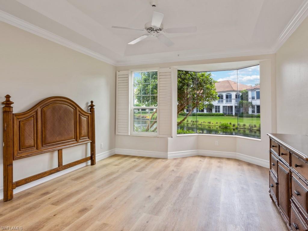 166 Colonade Circle Naples, FL 34103 - Photo 11 of 27 a view of empty room with wooden floor and fan