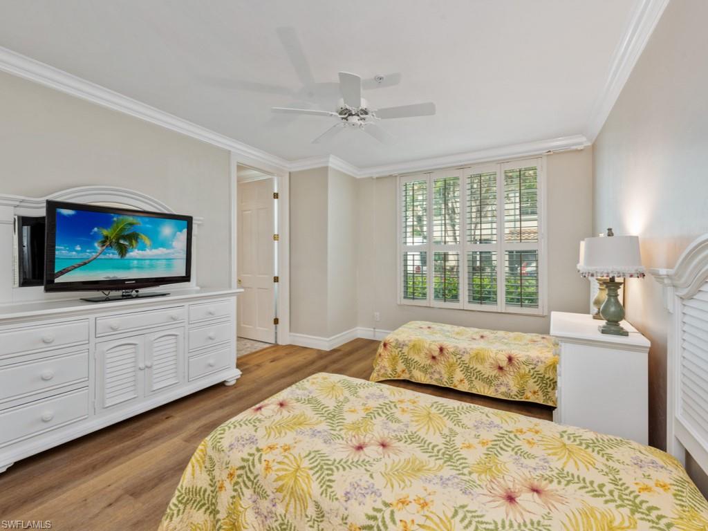 166 Colonade Circle Naples, FL 34103 - Photo 13 of 27 a bedroom with a bed and a flat screen tv