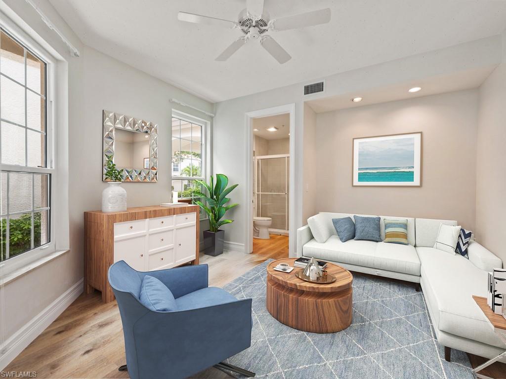 166 Colonade Circle Naples, FL 34103 - Photo 15 of 27 a living room with furniture and a large window