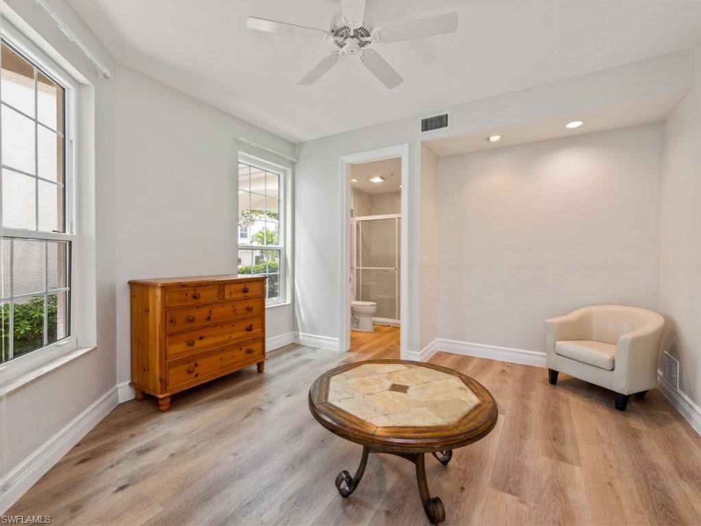 166 Colonade Circle Naples, FL 34103 - Photo 16 of 27 a living room with furniture and a wooden floor