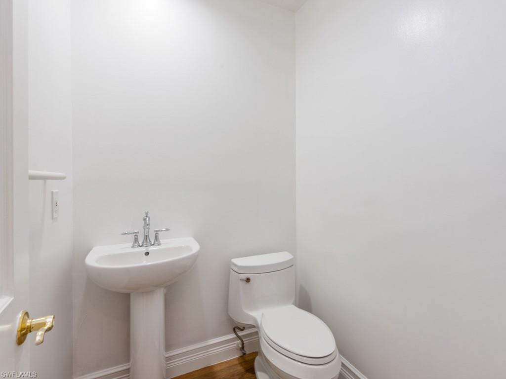 166 Colonade Circle Naples, FL 34103 - Photo 18 of 27 a white toilet sitting next to a white sink