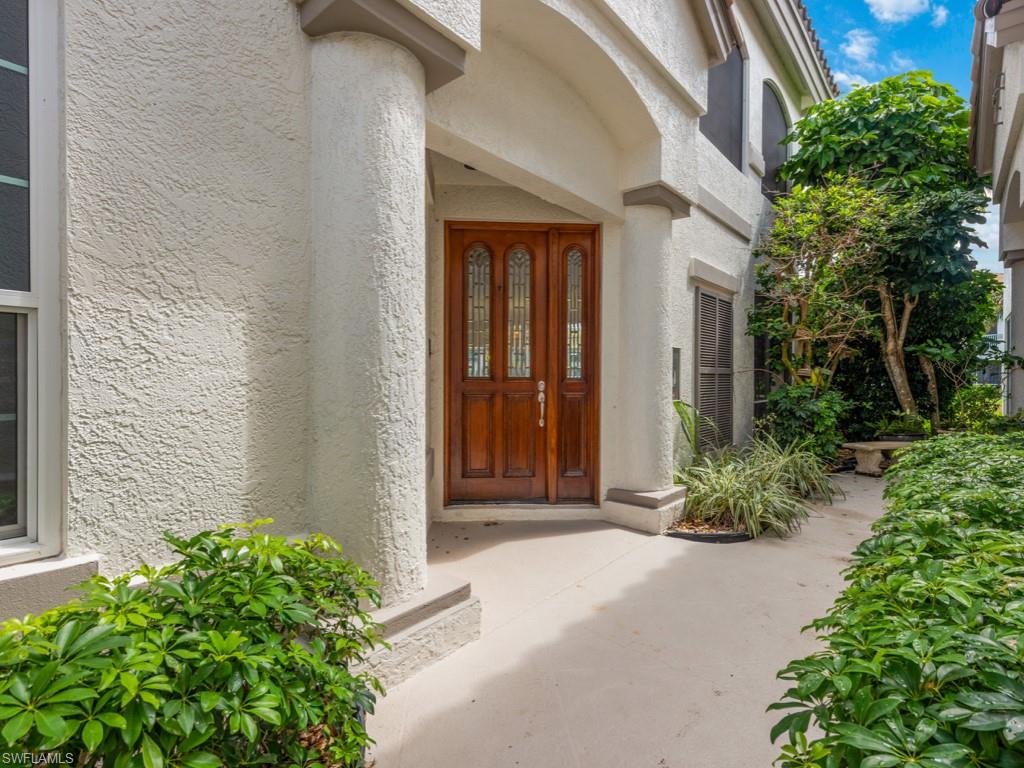 166 Colonade Circle Naples, FL 34103 - Photo 19 of 27 a front view of a house with garden