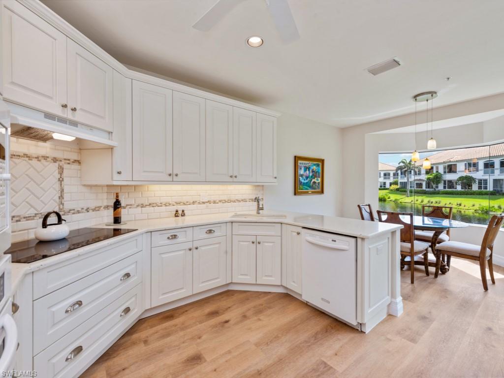 166 Colonade Circle Naples, FL 34103 - Photo 2 of 27 a kitchen with a sink and cabinets