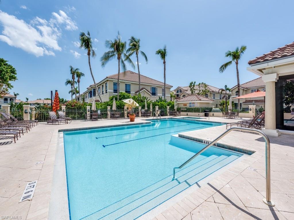 166 Colonade Circle Naples, FL 34103 - Photo 25 of 27 a view of swimming pool with outdoor seating and city view
