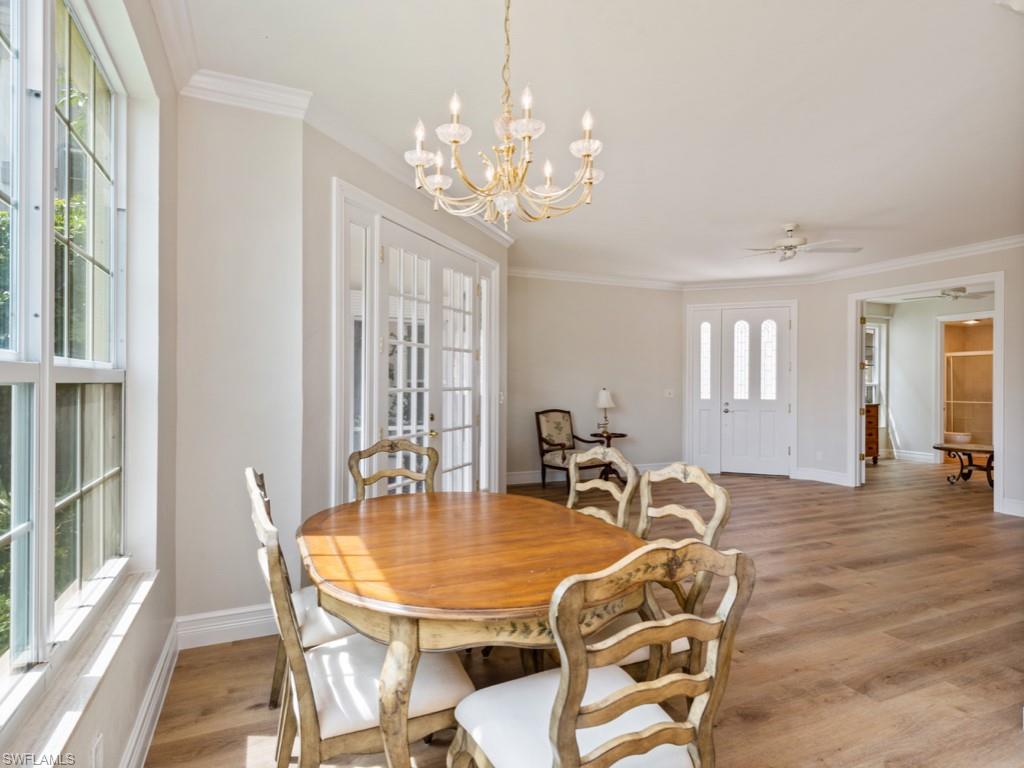 166 Colonade Circle Naples, FL 34103 - Photo 6 of 27 a view of a dining room with furniture window and wooden floor