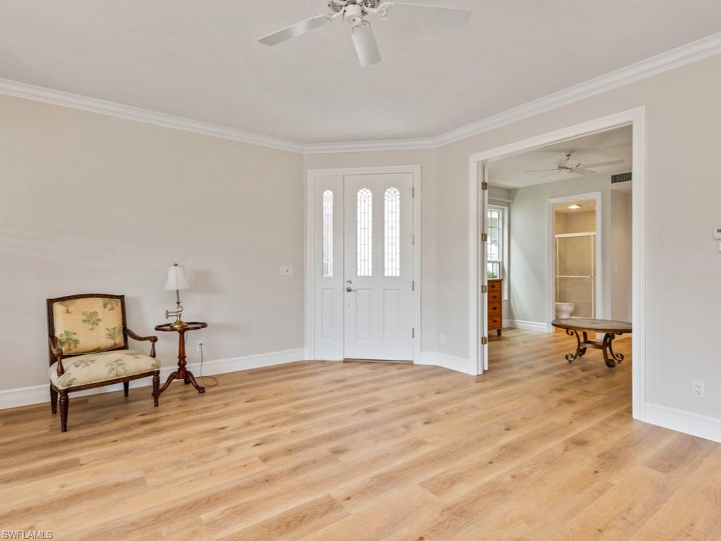 166 Colonade Circle Naples, FL 34103 - Photo 9 of 27 a view of a workspace with furniture and wooden floor
