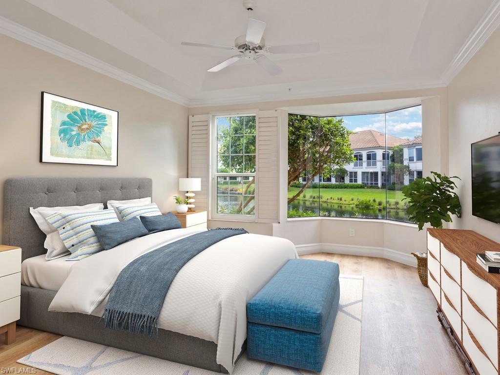 166 Colonade Circle Naples, FL 34103 - Photo 10 of 27 a spacious bedroom with a bed and a large window