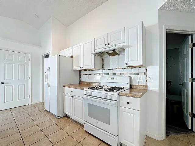 a bathroom with a sink a toilet a mirror and shower curtain