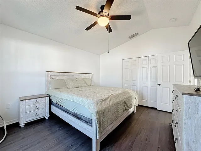 a view of a house with a swimming pool and a yard