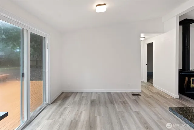 a view of a room with wooden floor and a bathroom