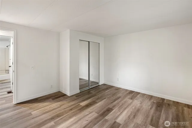 a view of an empty room and wooden floor