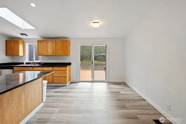 a view of kitchen with wooden floor and electronic appliances