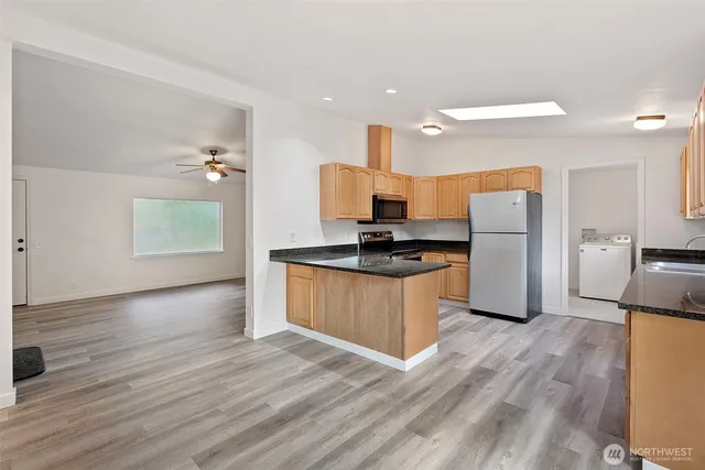 a kitchen with a refrigerator and a stove top oven