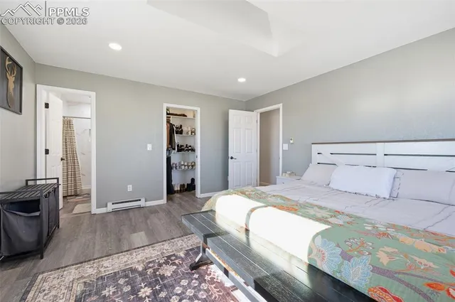 a bedroom with a large bed and a couch