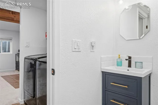 a bathroom with a sink vanity and a mirror