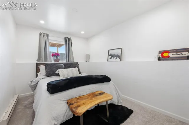 a bedroom with a bed and a table in it