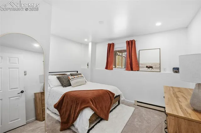 a bedroom with a bed and window