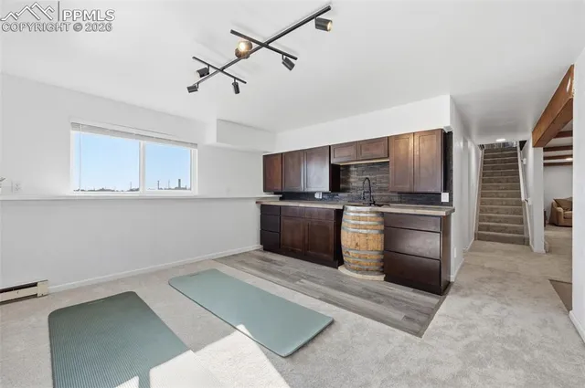 a kitchen with stainless steel appliances kitchen island granite countertop a stove and a sink