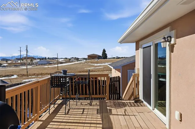 a view of a balcony with wooden floor