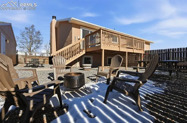 a view of a patio with couches table and chairs with wooden floor