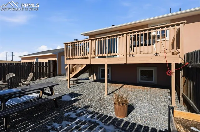 a balcony with table and chairs