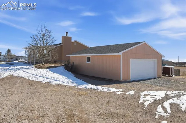 a view of a house with a snow in the yard