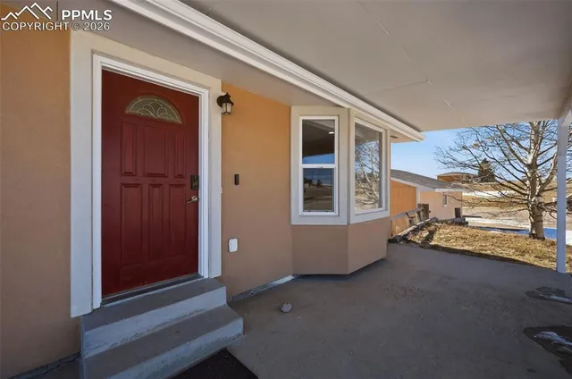 a view of an empty room and a window
