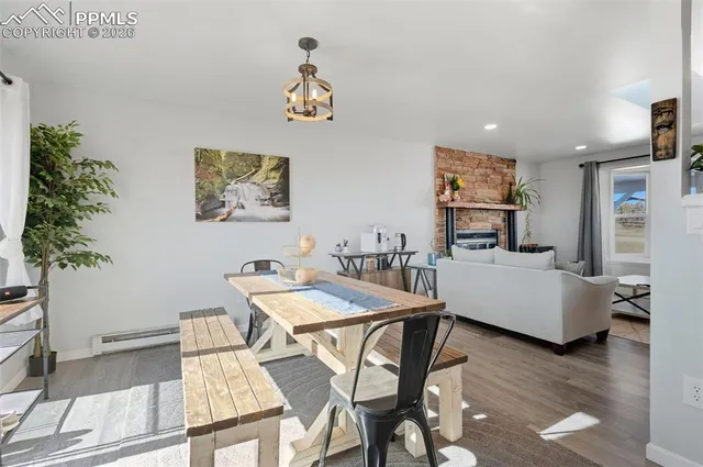a view of a workspace with furniture and wooden floor