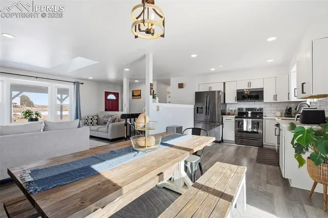 a living room with fireplace furniture and a wooden floor