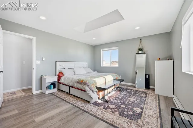 a spacious bedroom with a bed and a rug