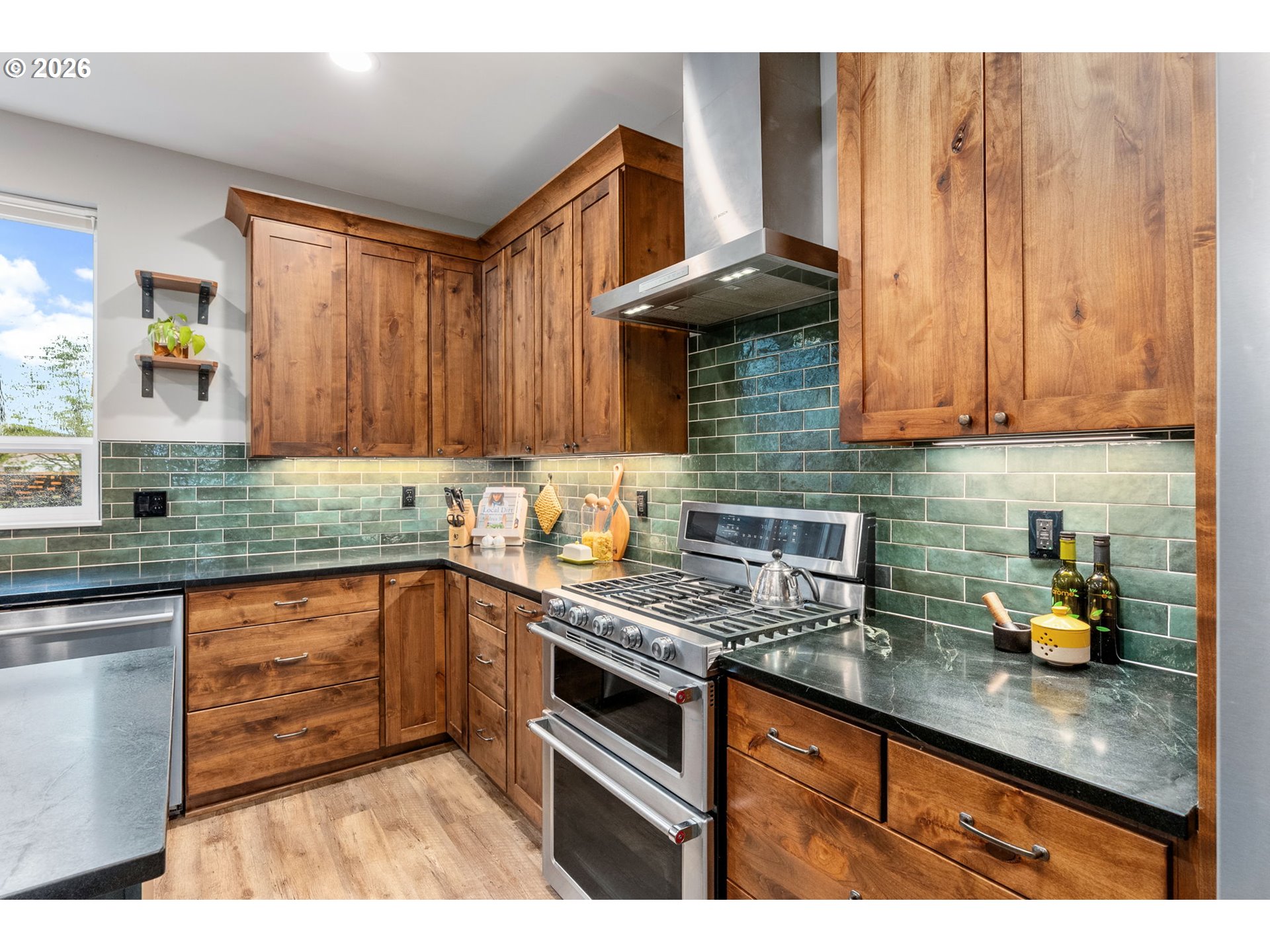 1114 9th Street Hood River, OR 97031 - Photo 11 of 48 a kitchen with granite countertop a sink stainless steel appliances wooden cabinets and a counter top space