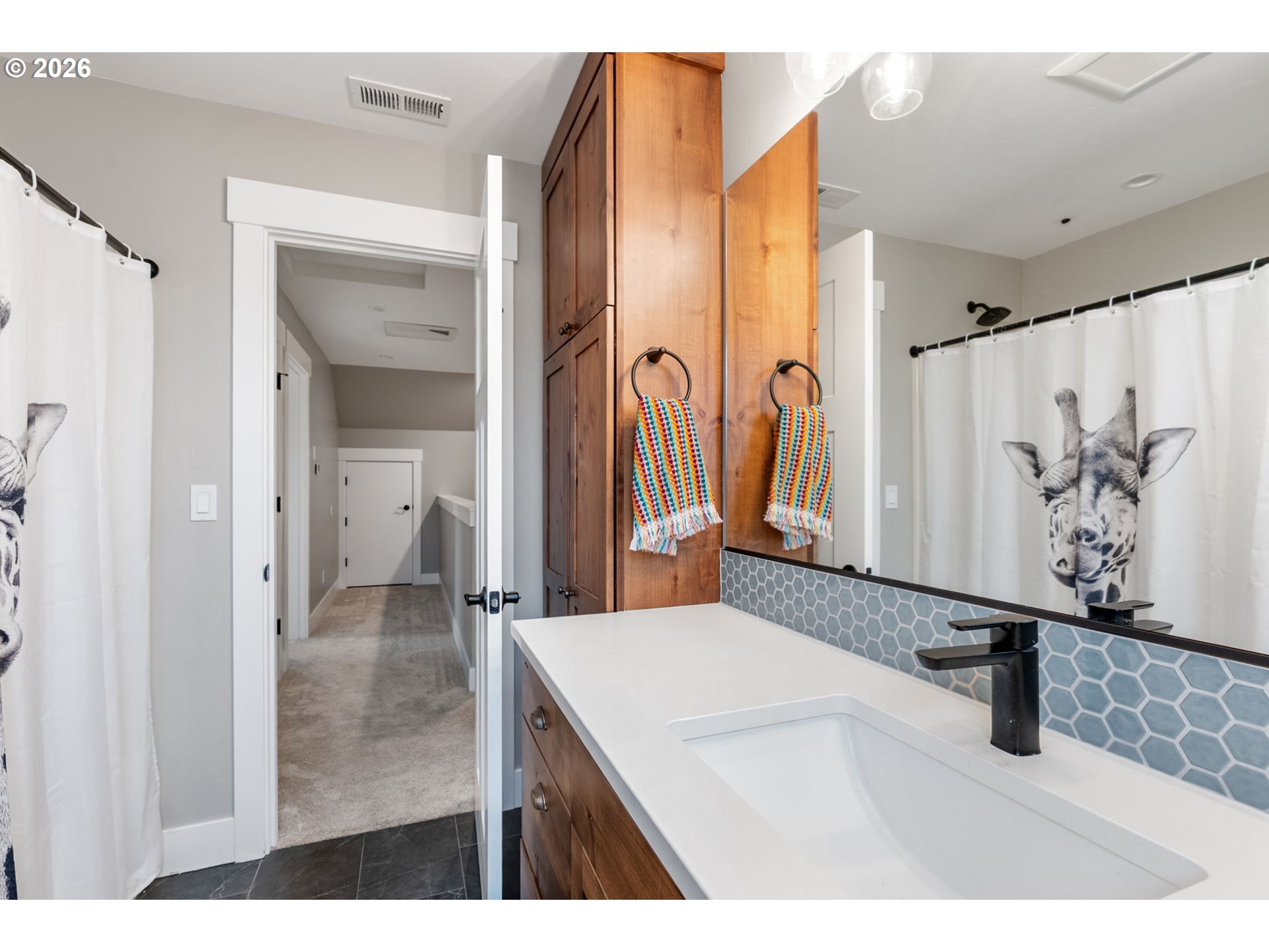 1114 9th Street Hood River, OR 97031 - Photo 29 of 48 a bathroom with a sink a mirror and a shower