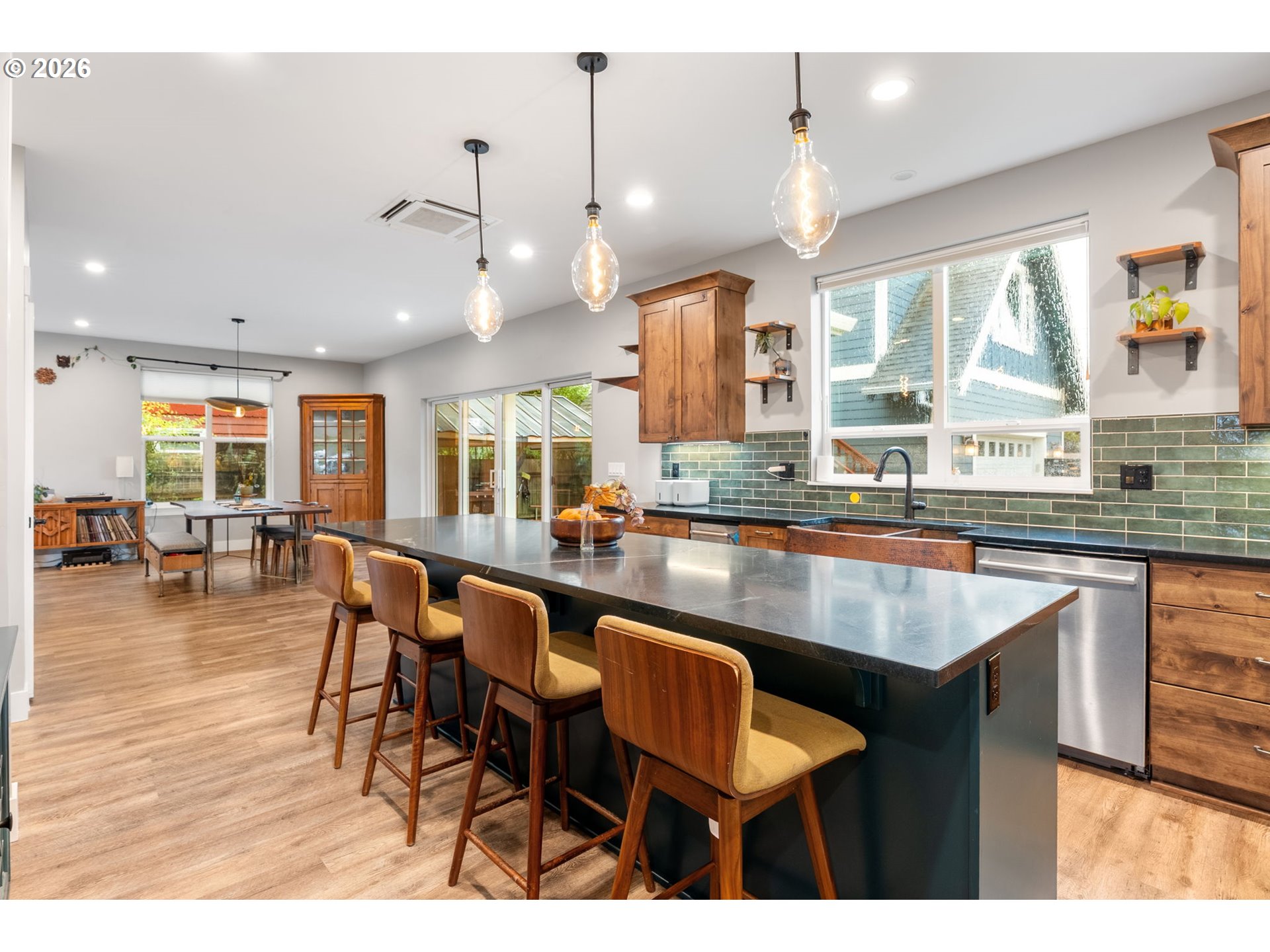1114 9th Street Hood River, OR 97031 - Photo 8 of 48 a kitchen with stainless steel appliances granite countertop table chairs and a view of living room