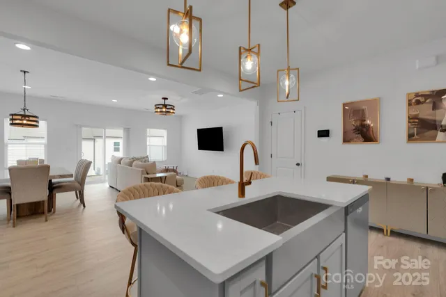 a kitchen with a sink a counter space and dining table